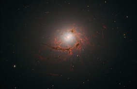 Супермассивная черная дыра красиво съедает галактику в кластере Центавра